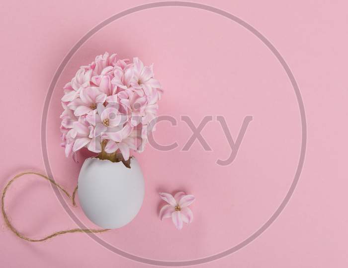 Easter Egg And A Pink Hyacinth Flower On Pink Background With Space For Copy