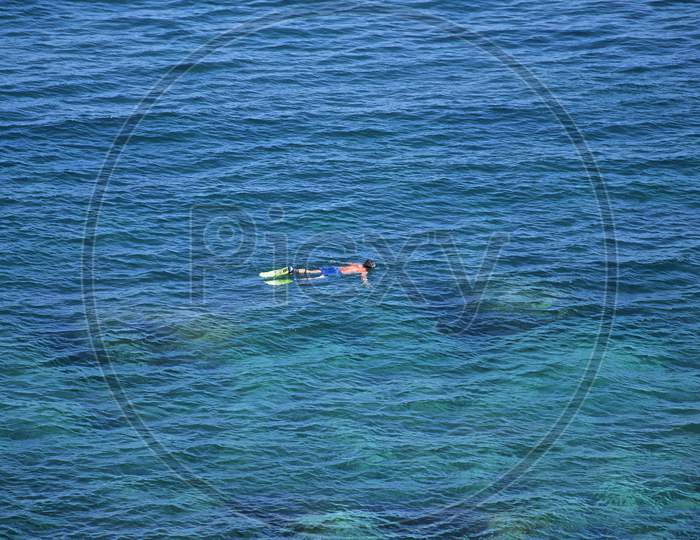 Man Floating On Blue Ocean Water Near Catania, Sicily