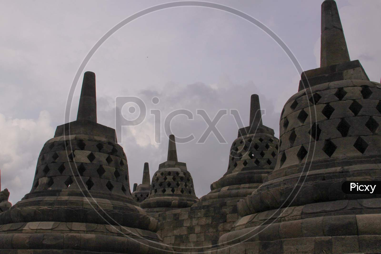 Stupas And Clouded Sky At Borobudur Temple, Java
