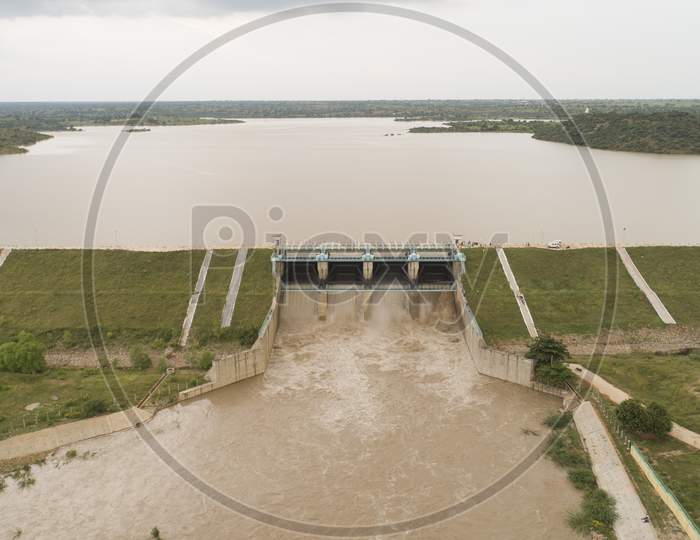 Aerial Bird Eye Of Water Reservoir With Full Of Water, All Reservoir Gates Open To Release Water At Raichur, India