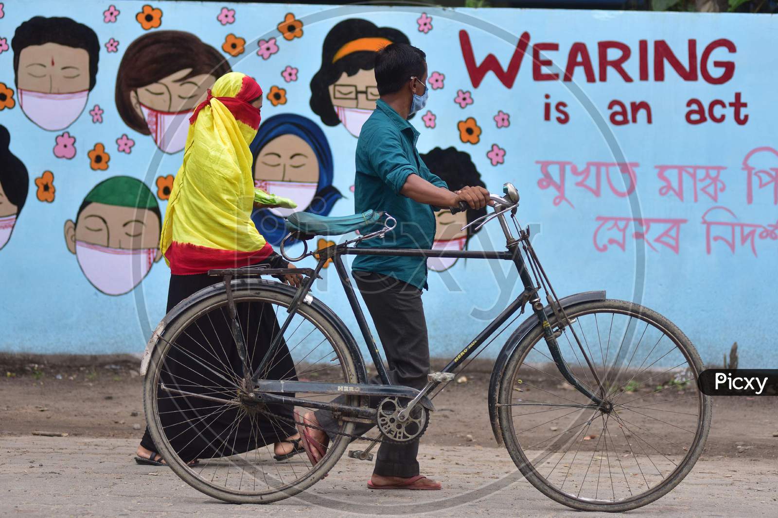 People Walks In Front Of Wall Graffiti During Ongoing Covid19 Lockdown In Nagaon District In The Northeastern State Of Assam On June 9,2020.