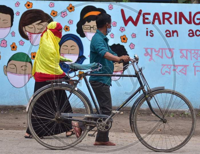 People Walks In Front Of Wall Graffiti During Ongoing Covid19 Lockdown In Nagaon District In The Northeastern State Of Assam On June 9,2020.