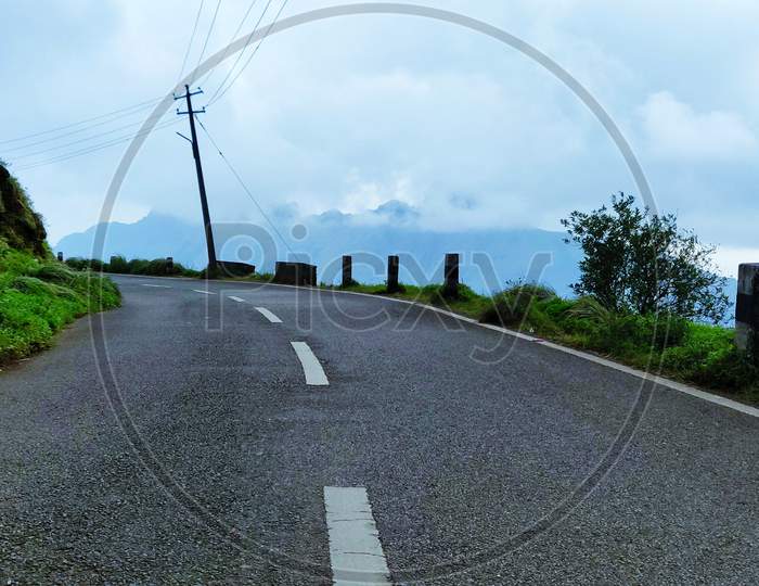 Panoramic View Of Empty Road Between The Hills In Ponmudi, Kerala, India. Copy Space (Text Space) Available.