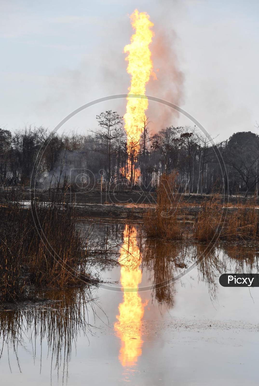 Flames And Smoke Come Out From A Well Run By State-Owned Oil India In Tinsukia District Of Assam On June 10,2020