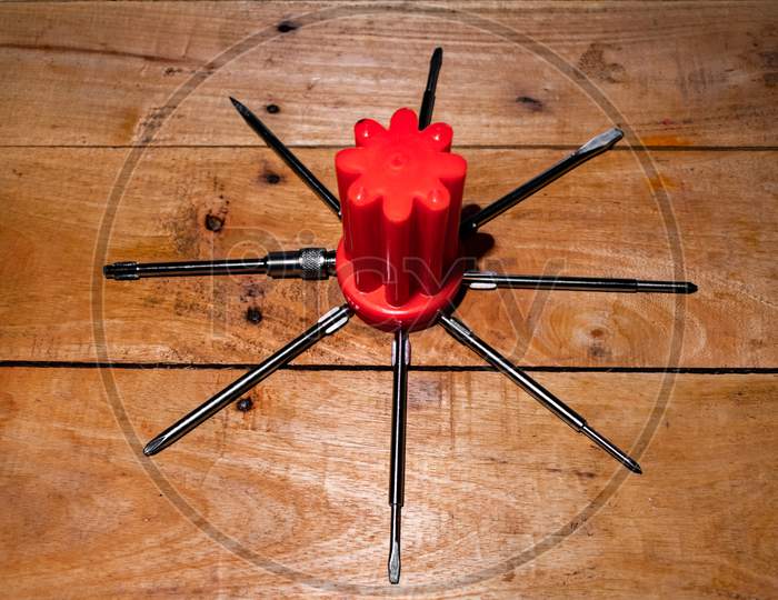 SCREW DRIVER SET ON A WOODEN TABLE