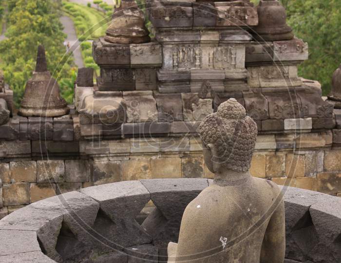 Back View Of Buddha Statue In Stupa At Borobudur