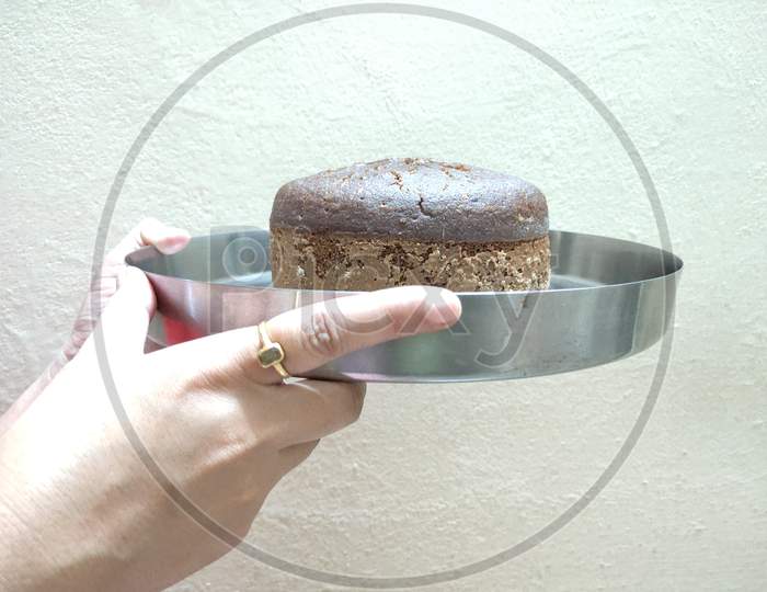 Baked cake in a plate. Simple baked cake. Brown cake serving in a plate.
