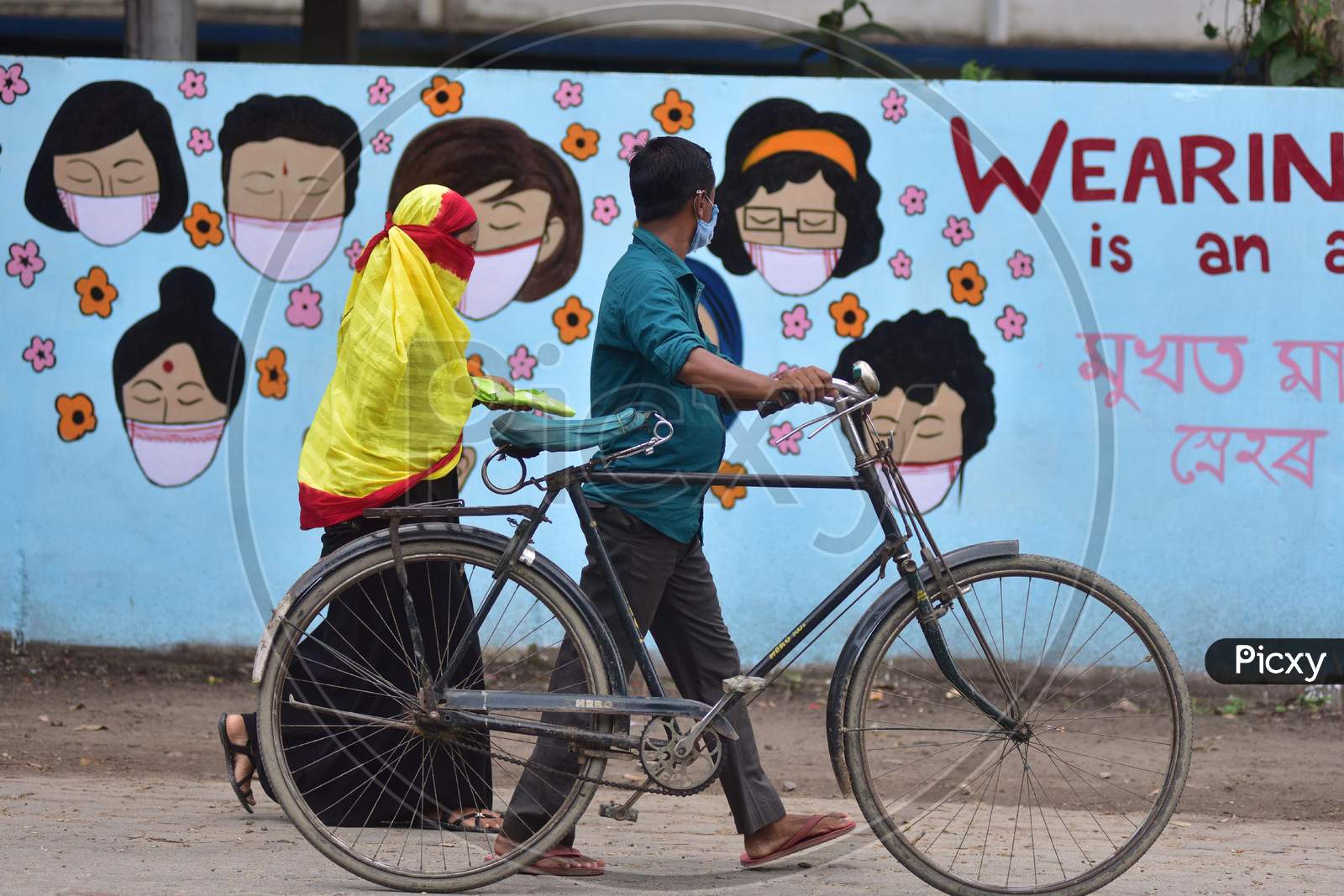 People  Walks In Front Of Wall Graffiti During Ongoing Covid19 Lockdown In Nagaon District In The Northeastern State Of Assam On June 9,2020.