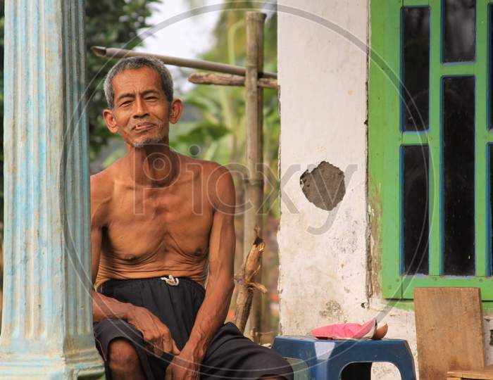 Old Indonesian Man On Porch Of His House In Java