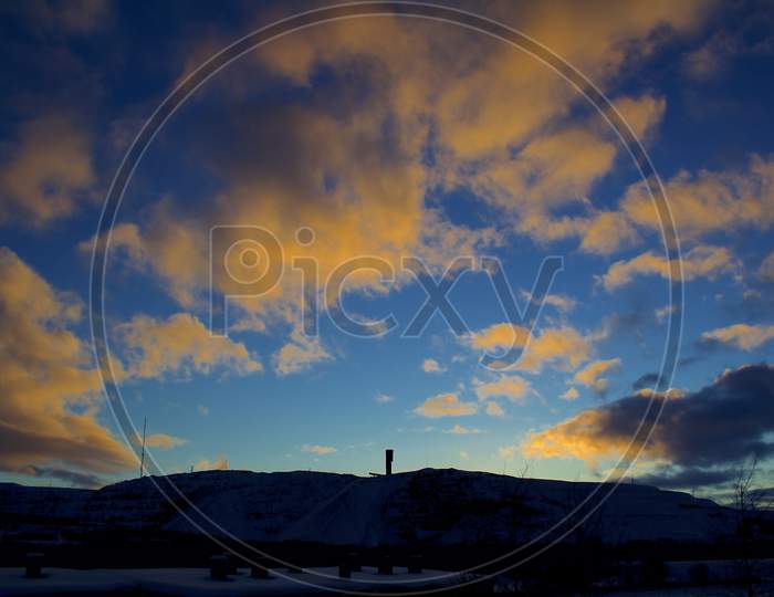 Silhouette Of Kiruna Iron Ore Mine With Beautiful Orange Twilight Sky In The Background