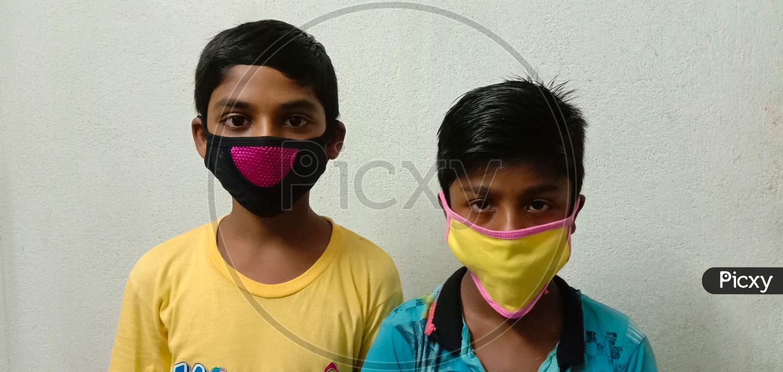 Corona virus protection by face mask.Two boys wearing mask for air pollution with white background.