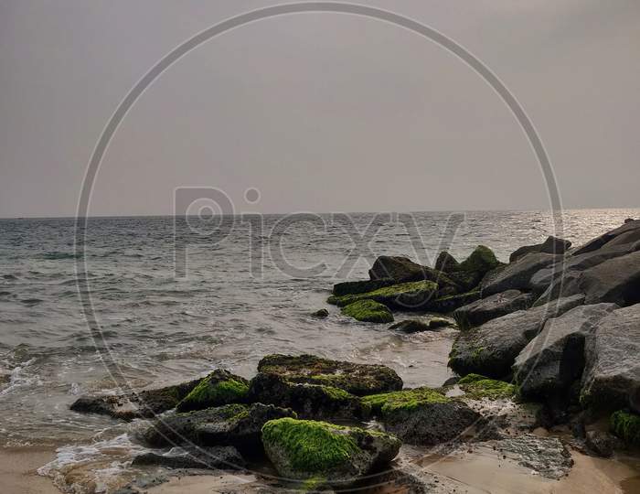 Calm Beach With Rocks On A Partly Cloudy Day. Anchuthengu Beach, Kerala, India.