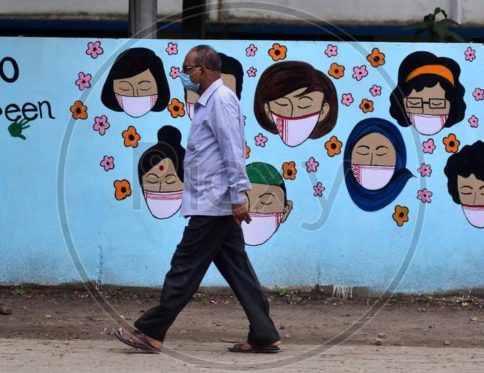 A Man Walks In Front Of Wall Graffiti During Ongoing Covid19 Lockdown In Nagaon District In The Northeastern State Of Assam On June 9,2020.