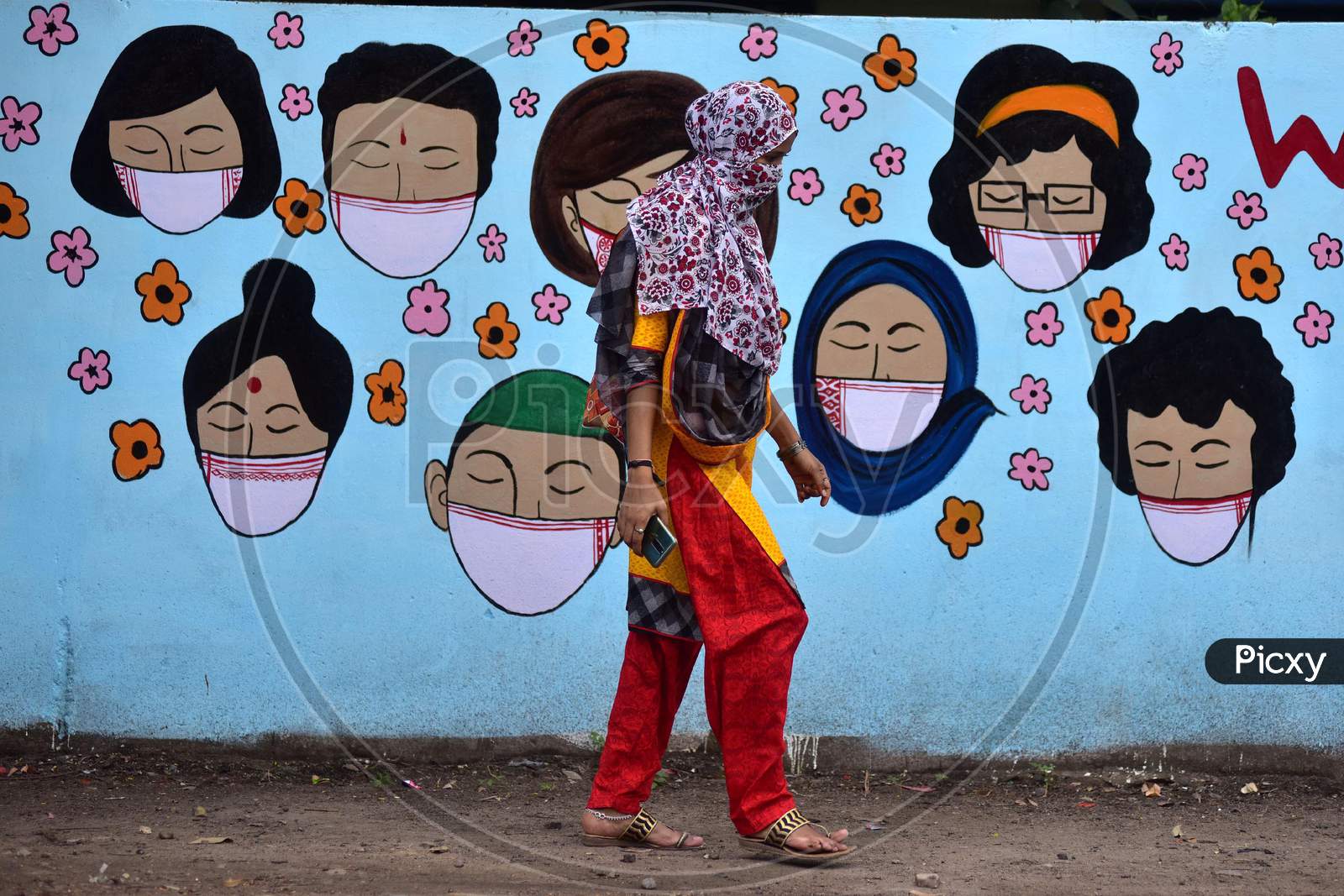 A Woman Walks In Front Of Wall Graffiti During Ongoing Covid19 Lockdown In Nagaon District In The Northeastern State Of Assam, India On June 9,2020