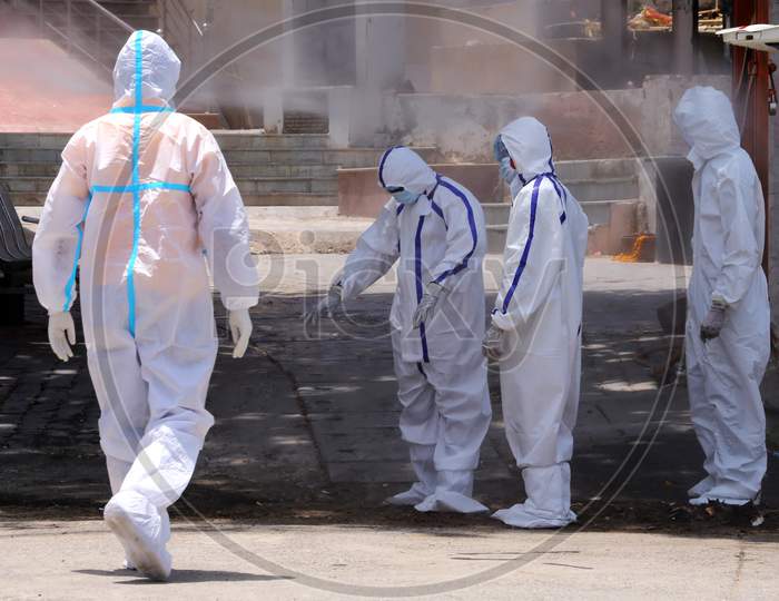 Health Workers Wearing Personal Protective Equipment (Ppe) Disinfect As A Preventive Measure Against The Spread Of The New Coronavirus Covid-19, After A Cremation Of A Woman, Who Died Of Covid-19 In Ajmer, Rajasthan, India On June 9, 2020.