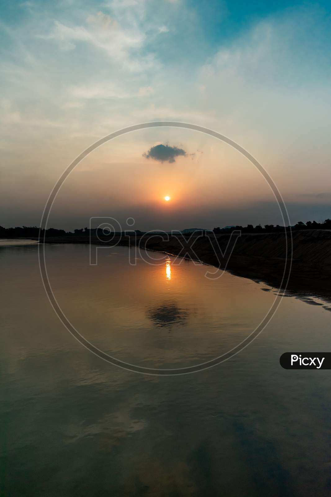 SUNSET WITH ITS REFLECTION ON RIVER WATER SURFACE