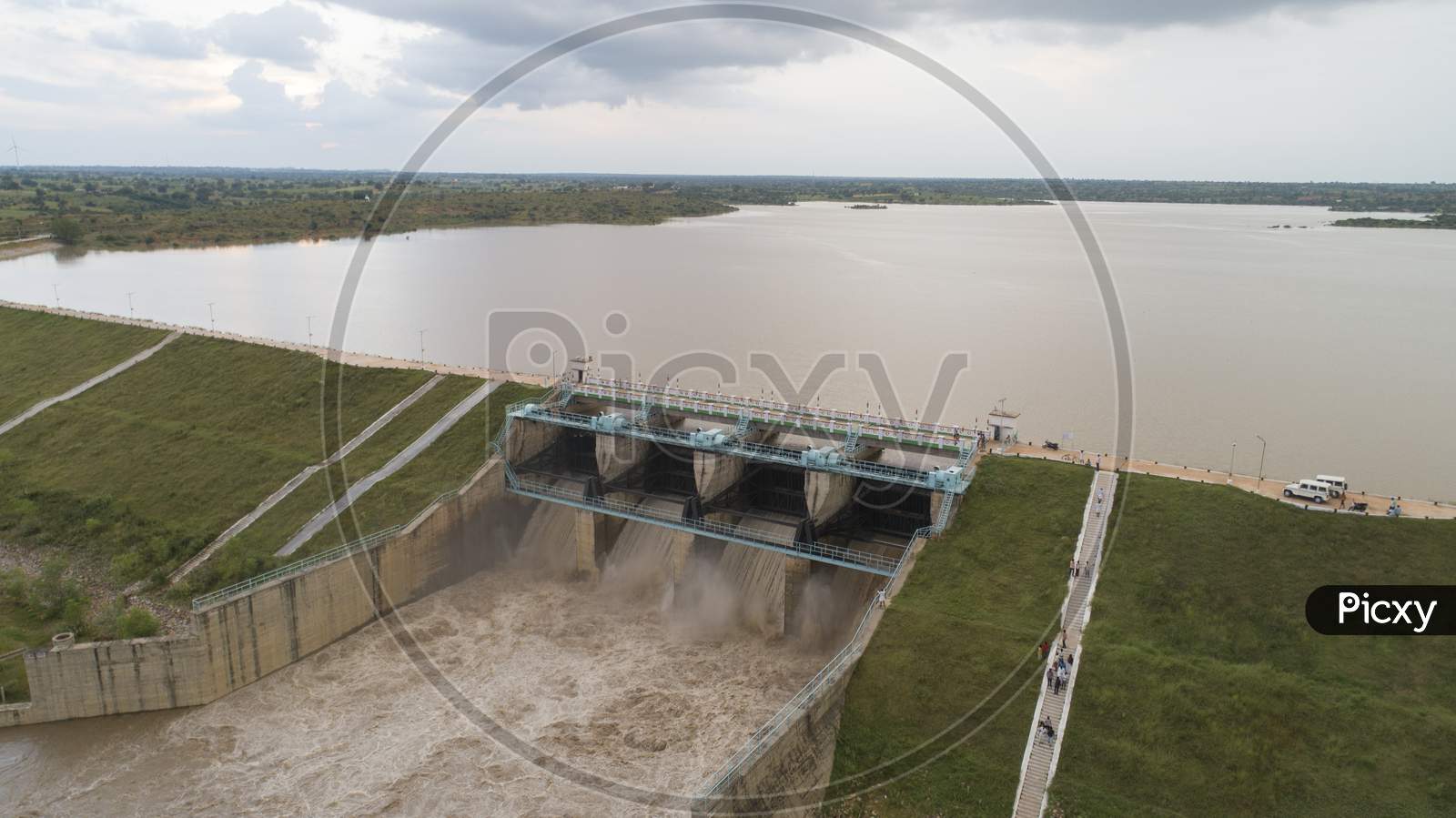 Aerial Bird Eye Of Water Reservoir Flood Gates Open To Release Water During Monsoon Flood From Dam At Raichur, India