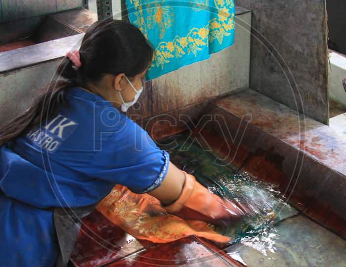 Worker Washes Dyed Batik In Winotosastro Factory