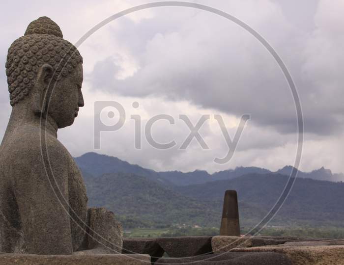 Side View Of Praying Buddha Statue At Borobudur