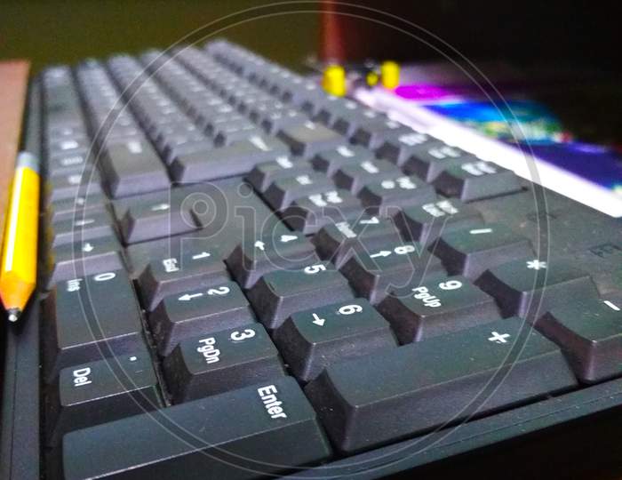 A computer keyboard is an input device used to enter characters and functions into the computer system by pressing buttons, or keys. It is the primary device used to enter text. A keyboard typically contains keys for individual letters, numbers and special characters.