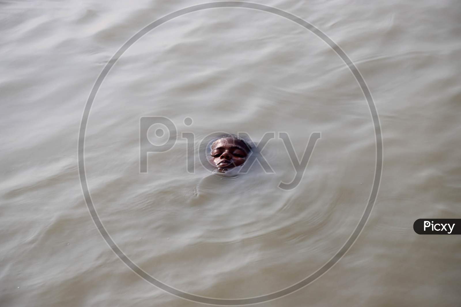 A Boy Jumps In The River Ganga To Beat The Heat On A Hot Day In Prayagraj, June 10, 2020.