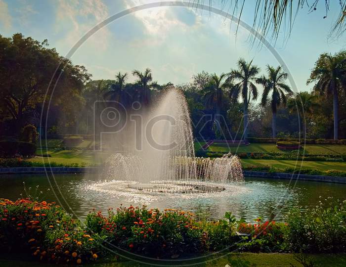 Beautiful park with beautiful fountain blue sky trees flower