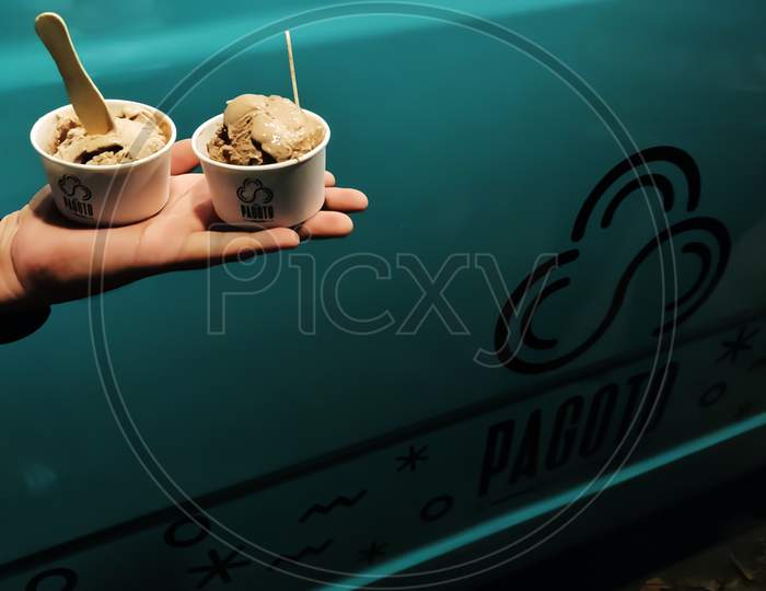 28/12/2018- Trivandrum, India: Hand Of A Person Holding Two Small Scoops Of Chocholate Ice Cream In From Ice Cream Truck Named Pagoto Wagon In Trivandrum, India.