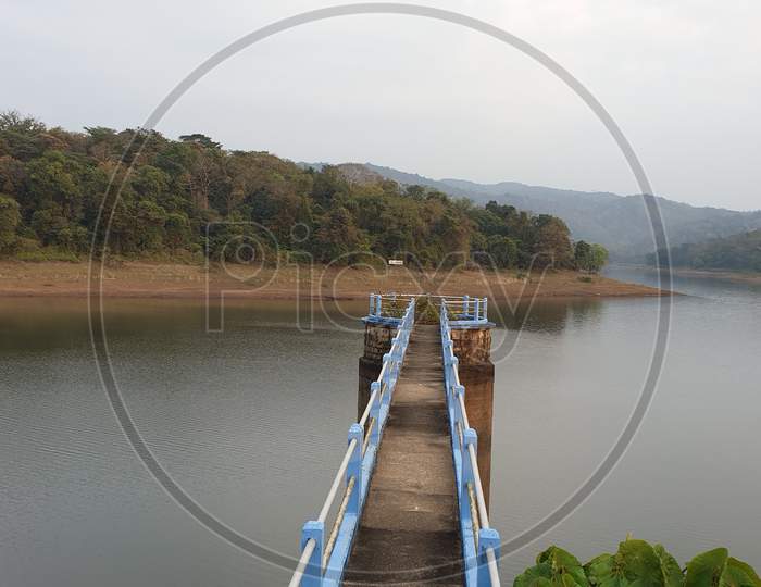 Walkway Bridge at Vazhani Dam Reservoir In Kerala, India.