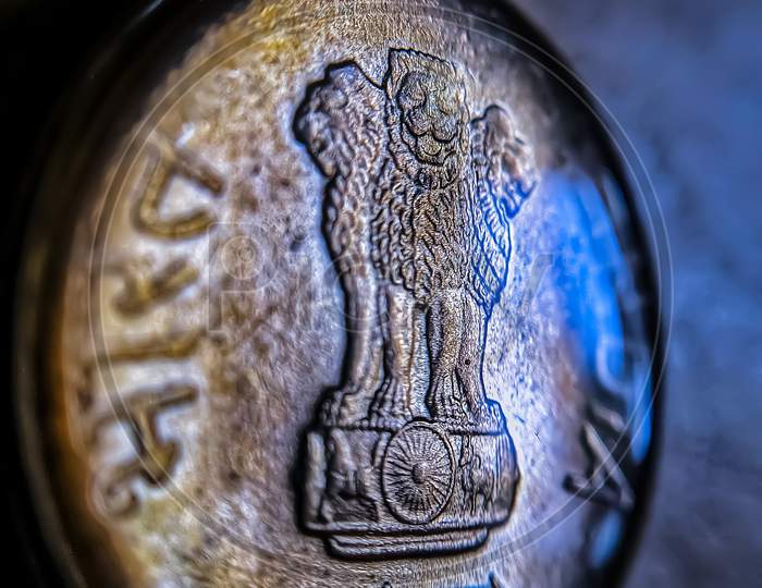 Micro Shot Of Five Indian Rupees Coin Covered With Water Drop.