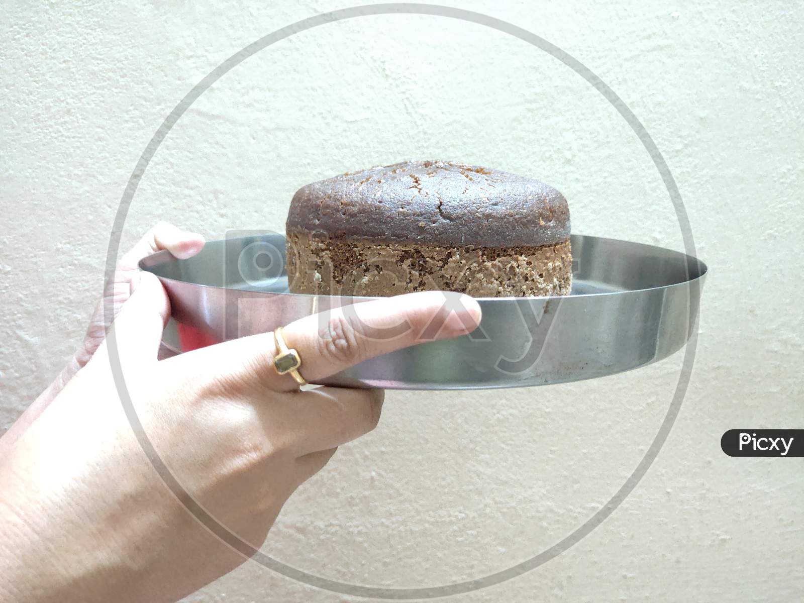 Baked cake in a plate. Simple baked cake. Brown cake serving in a plate.