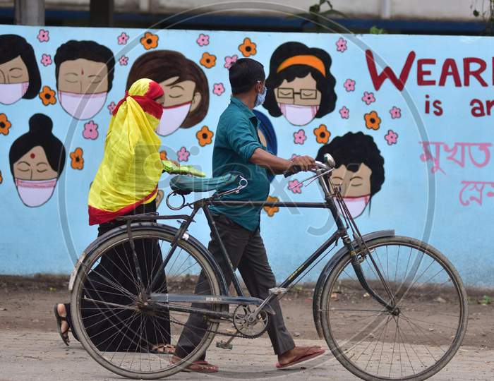 People  Walks In Front Of Wall Graffiti During Ongoing Covid19 Lockdown In Nagaon District In The Northeastern State Of Assam On June 9,2020.