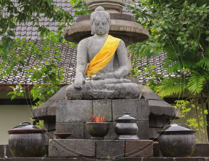 Sitting Buddha With Yellow Scarf In Indonesia