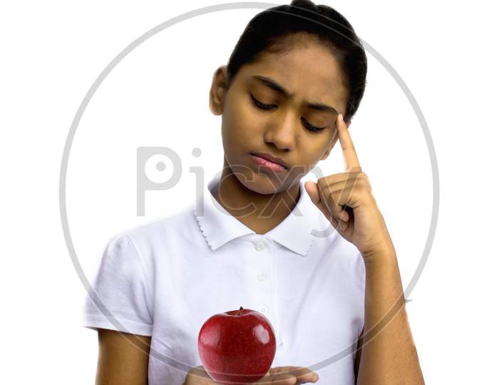 Portrait of a Young Indian School Girl Holding a Apple