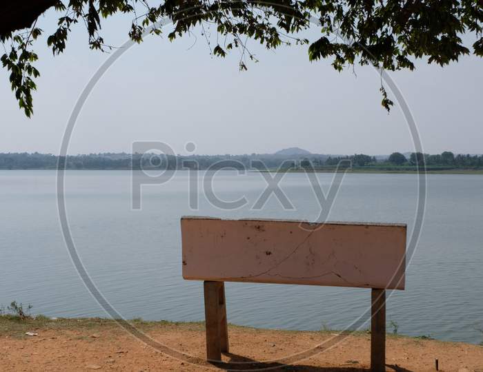 Lone stone bench overlooking a lake