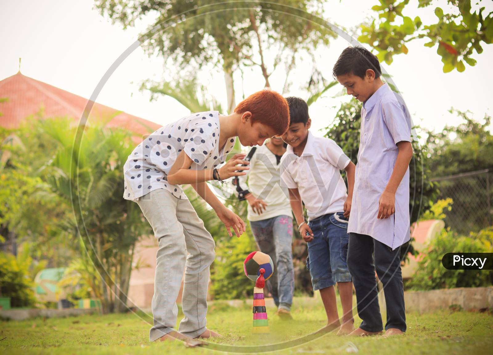 Image Of Children Playing Lagori Dikori Or Lagoori Outdoor Traditional Game Where Two Teams Try To Hit A Pile Of Stones With Ball Concept Of Kids Enjoying Outdoor Games In Technology