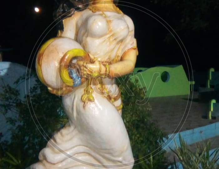 unedited stone sculpture of goddess ganga in a park