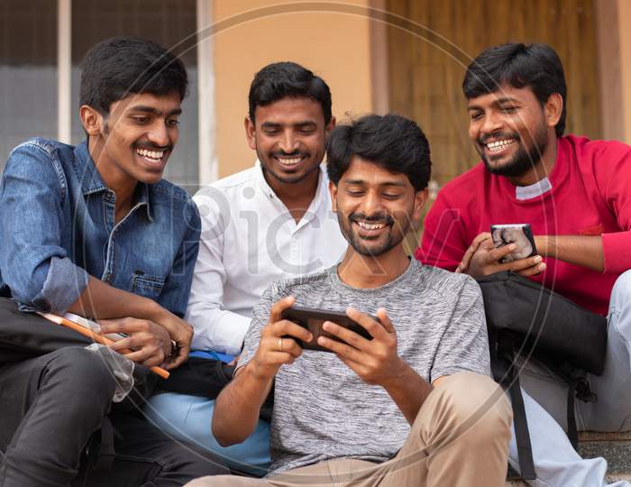 Group of Students using  mobile phones or Smartphones At College - Education, Learning Student, People Concept