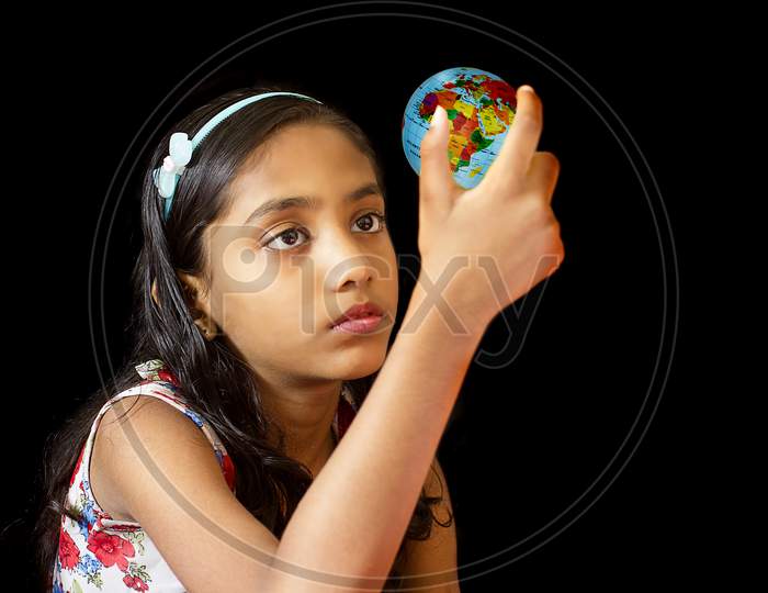 Portrait of a Young Indian School Kid holding a Globe