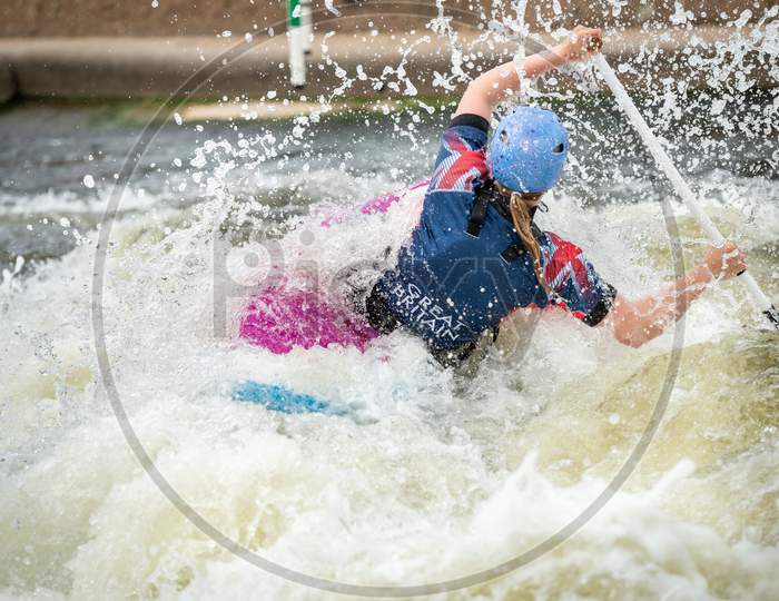 Gb Canoe Slalom Athlete In C1W Class In White Water Action. Paddling Away And Surrounded By Splashes