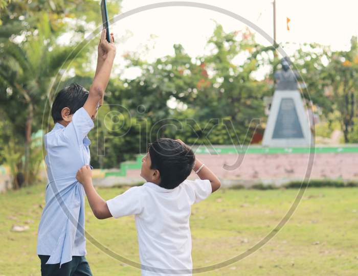 Children's Playing Games At a Park