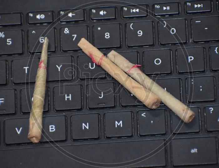 Indian weed called Bidi is lying on a keyboard
