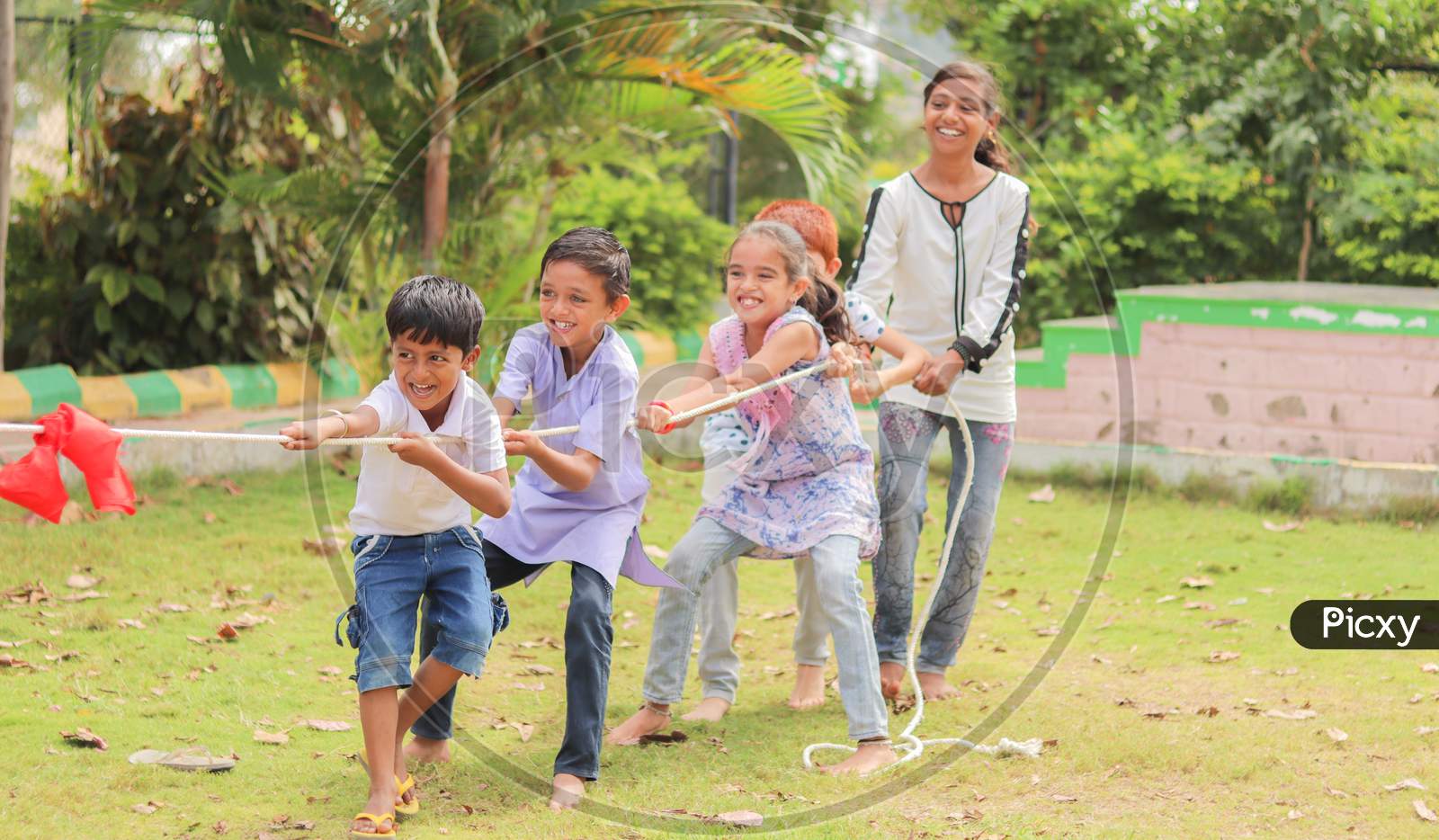 Image of Group Of Multi Racial Children Playing Tug Of War Game  Kindergarten - Multi Ethnic Kids Playing Outdoor Games Against  Racism.-TC243462-Picxy