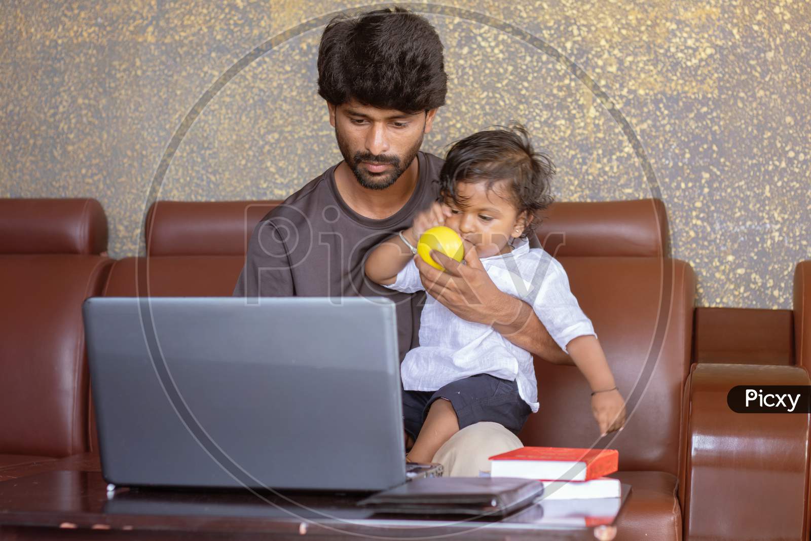 Young Father With His Little Son Working On Laptop At Home - Concept Of Work Form Home Or Wfh Reality, People Lifestyles And Technology