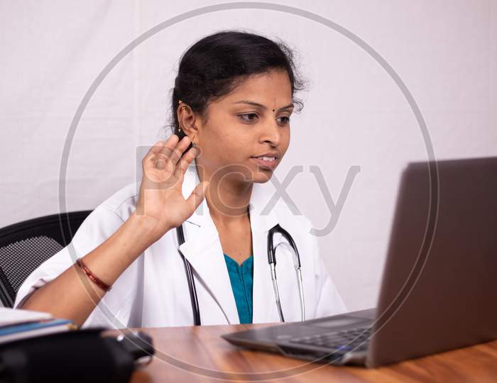 A Doctor Talking to Patients through a Video Call using a Laptop due to Corona Virus or COVID 19 Effect