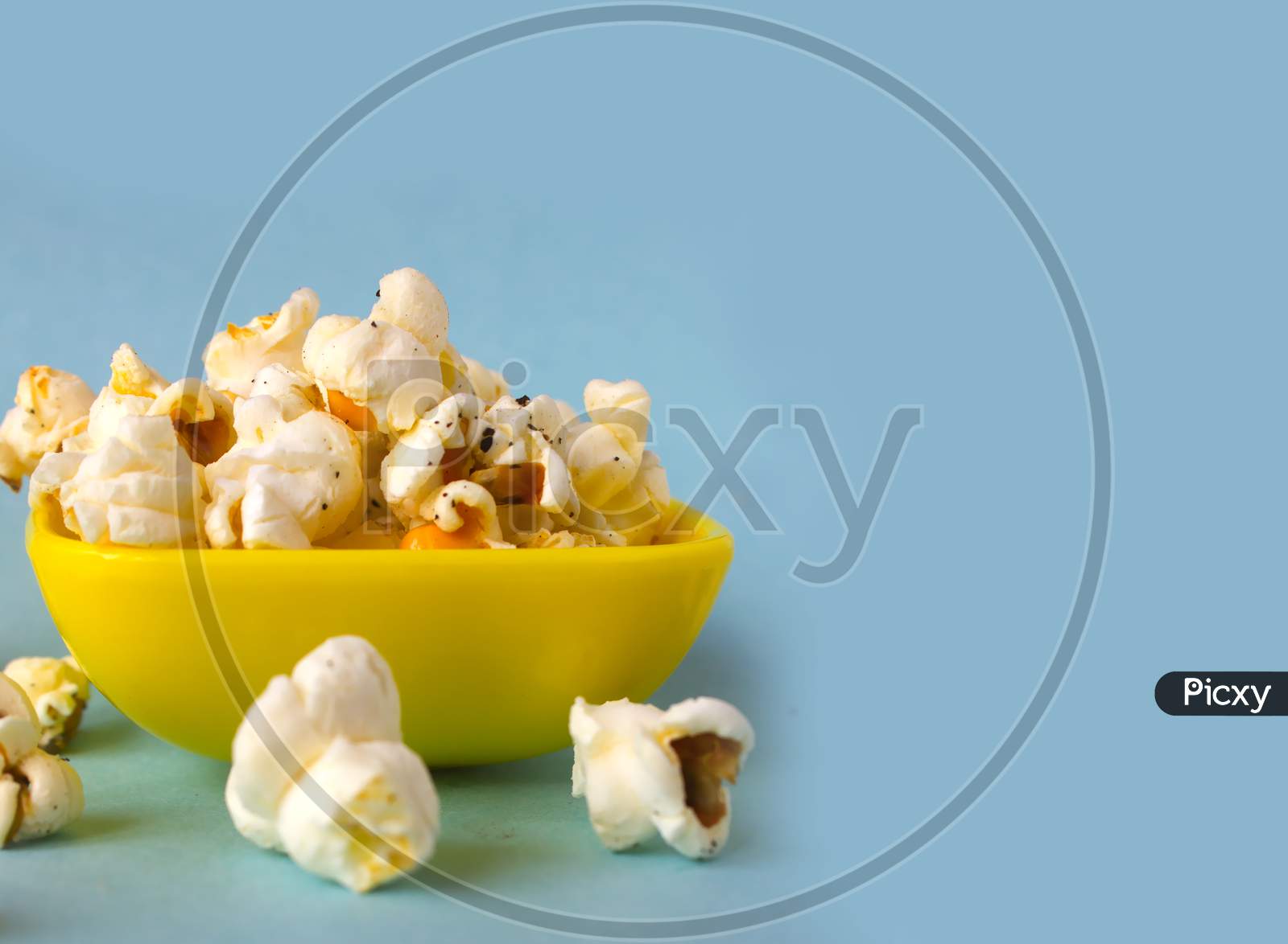 Pop Corns in a Bowl with blue Background