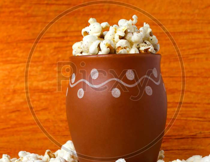 Pop Corns in a Bowl with brown Background