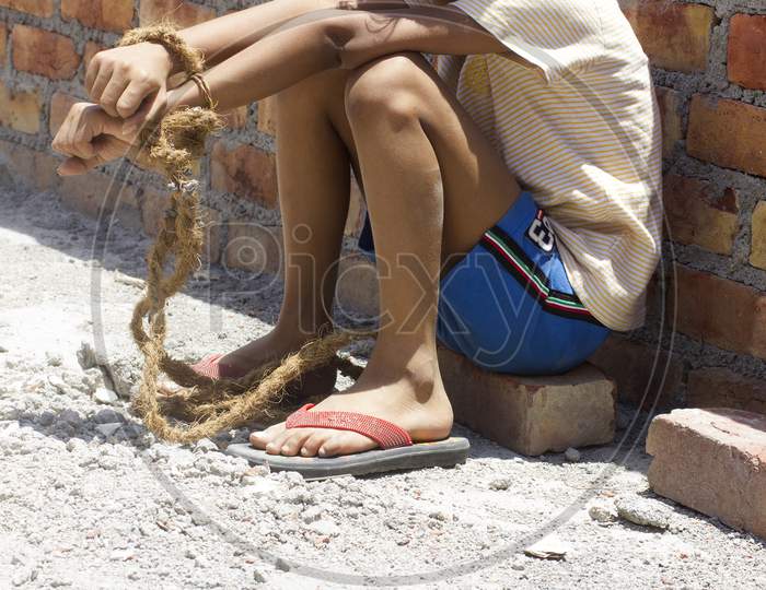 A kid's hands tide with a Rope