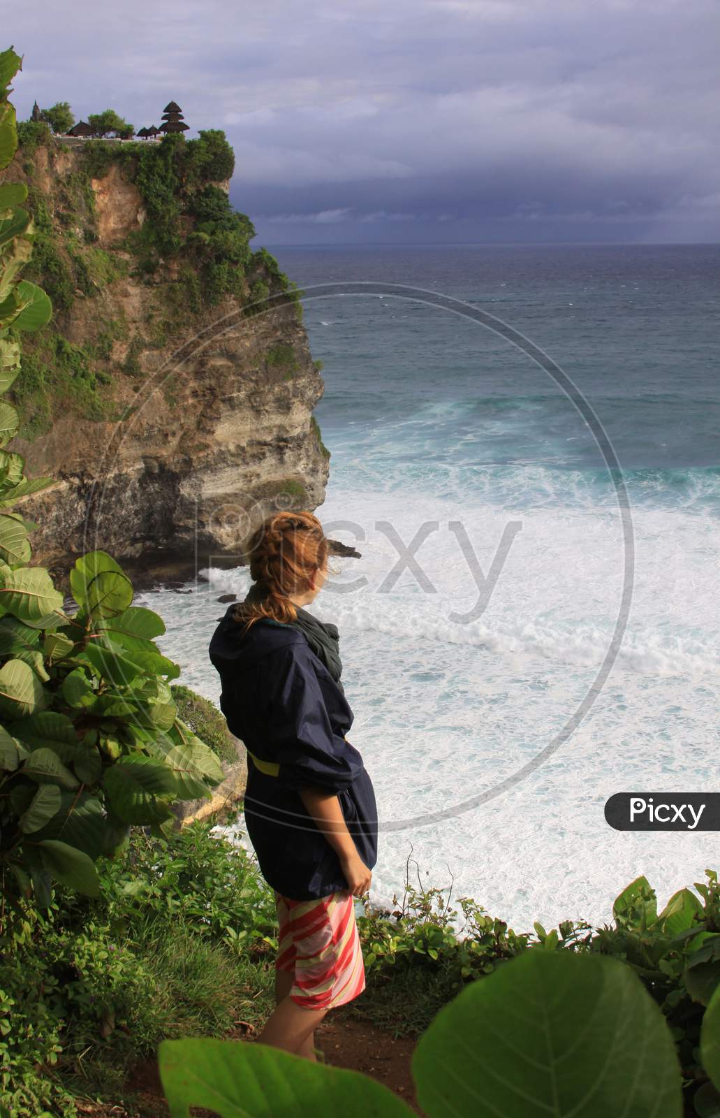 Woman At Uluwatu Bali Looking At Waves And Ocean
