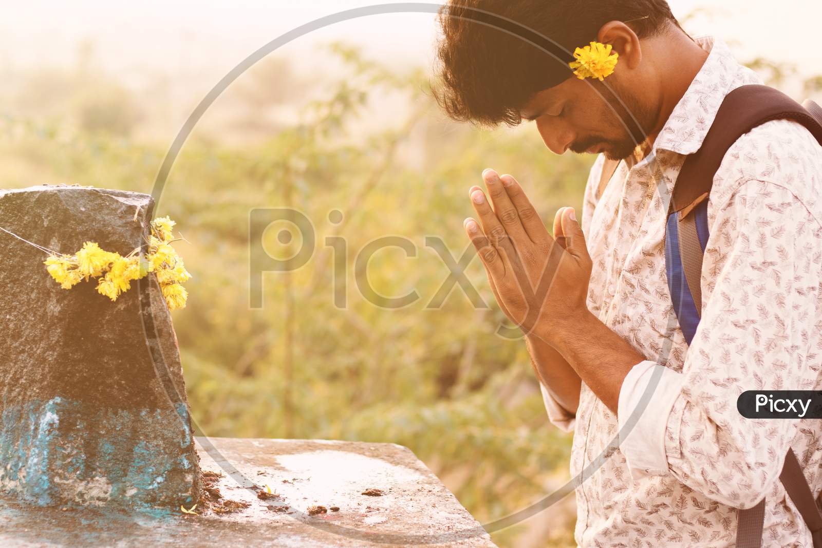 A Young Man praying to God before going to College