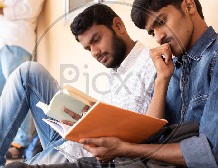 Group Of Students studying by Looking Into Books At College - Education, Learning Student, People Concept
